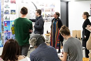 Nikole Bouchard (center, in stripes) works with students in a studio class at the University of Wisconsin-Milwaukee.