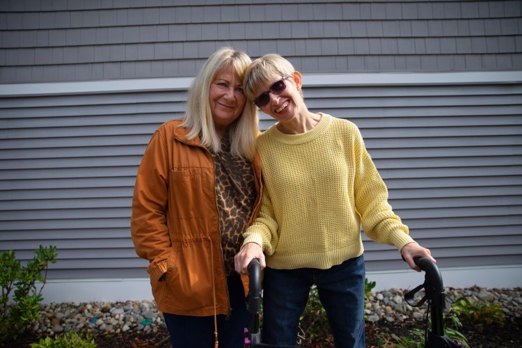 Debbie Dionne and her daughter Kate Riordan, 41, at the group home where Kate lives in Brunswick on Sept. 30. Constant staff turnover at the home has made life more difficult for Riordan.