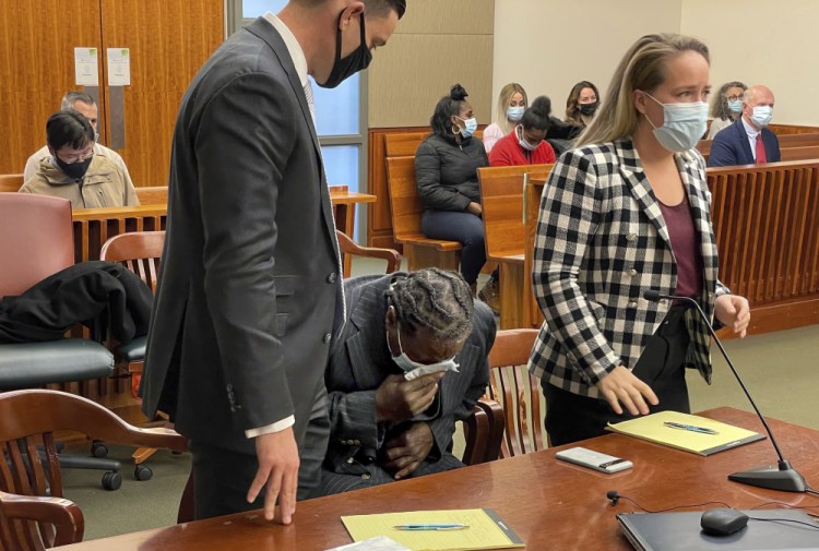 Anthony Broadwater breaks down crying Monday in Syracuse, N.Y., when a judge overturned his 40-year-old rape conviction. With him are his lawyers David Hammond, left, and Melissa Swartz. Broadwater, who spent 16 years in prison, was cleared Monday by a judge of raping Alice Sebold when she was a student at Syracuse University, an assault she wrote about in her 1999 memoir, "Lucky." 