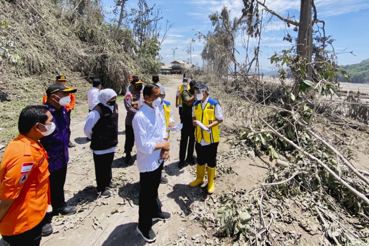 Indonesian President Joko Widodo, center, inspects an area covered in ash from the eruption of Mount Semeru in Lumajang district, East Java province, on Tuesday
