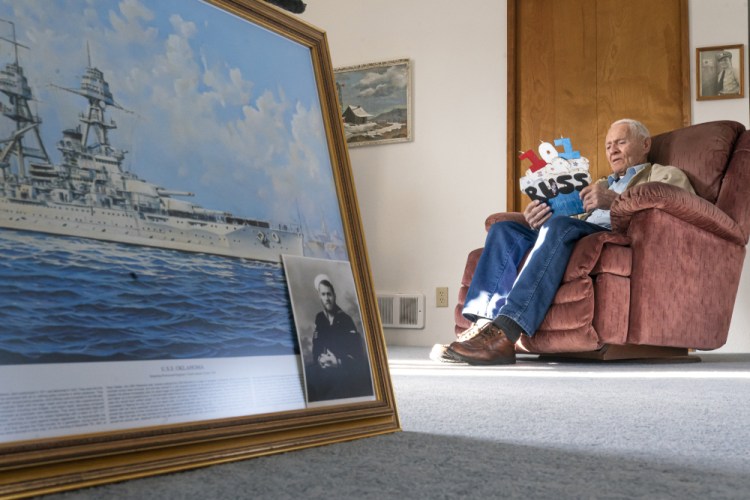 Pearl Harbor survivor and World War II Navy veteran David Russell, 101, reads a birthday card while talking about his time aboard the USS Oklahoma and his life after the war, last month in Albany, Ore. 