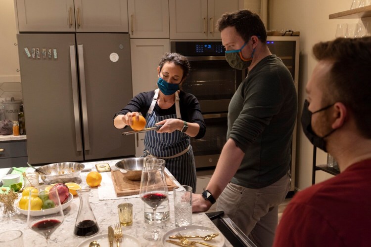 Chef Amy Kayne shows Dylan Doughty, of Bath, how to zest an orange during a recent cooking class at The Maker’s Galley in Portland.