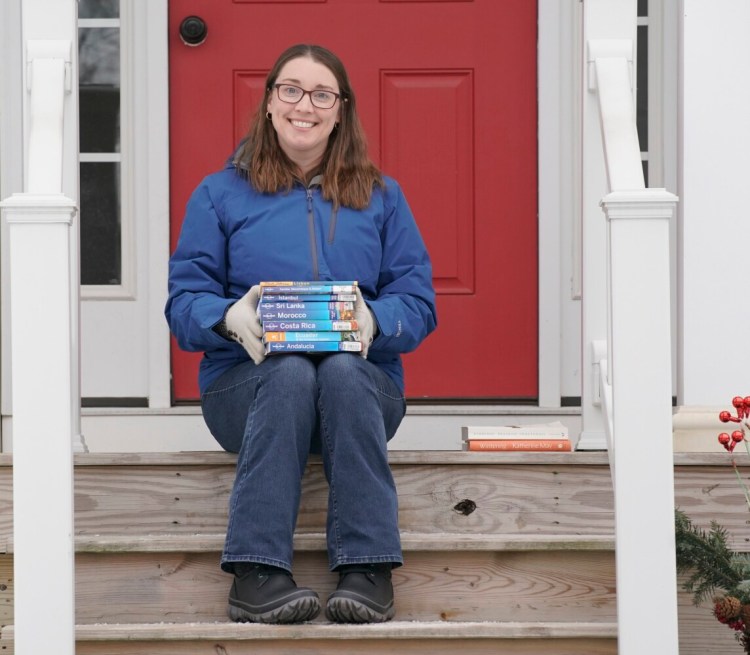 WESTBROOK, ME – JANUARY 14: Amy Cookson of Westbrook is an avid reader and has been doing some light, escapist reading during the pandemic, including travel guides by Rick Steves, Rough Guides and Lonely Planet. Photographed at her home in Westbrook on Friday, January 14, 2022. (Staff photo by Gregory Rec/Staff Photographer)