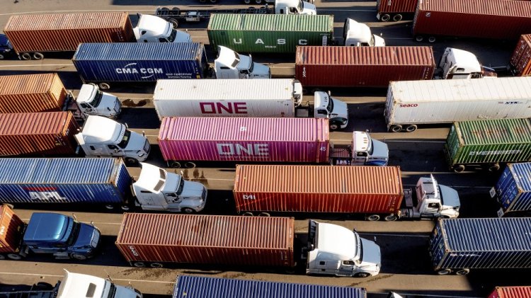 Trucks line up to enter a Port of Oakland shipping terminal on Nov. 10, 2021, in Oakland, Calif. The pandemic has receded as a top priority in many voters’ minds to start 2022, with the economy overshadowing coronavirus concerns and worries about inflation on the rise, a poll from The Associated Press-NORC Center for Public Affairs Research finds. 