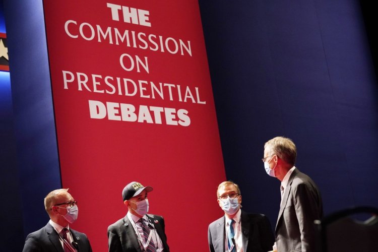 Officials from the Commission on Presidential Debates gather near the stage before the start of the second and final presidential debate on Oct. 22, 2020, at Belmont University in Nashville, Tenn. 