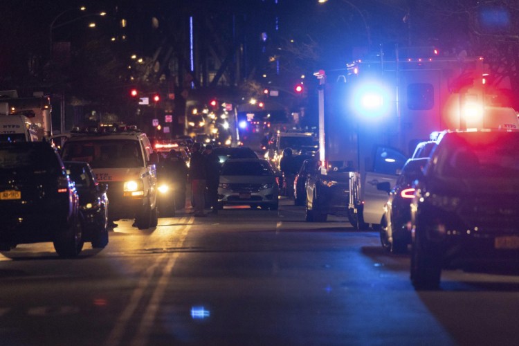 Officers work at the scene of the shooting Friday in Harlem. A New York Police Department officer was killed and another was gravely injured after responding to a domestic disturbance call, according to a law enforcement official.