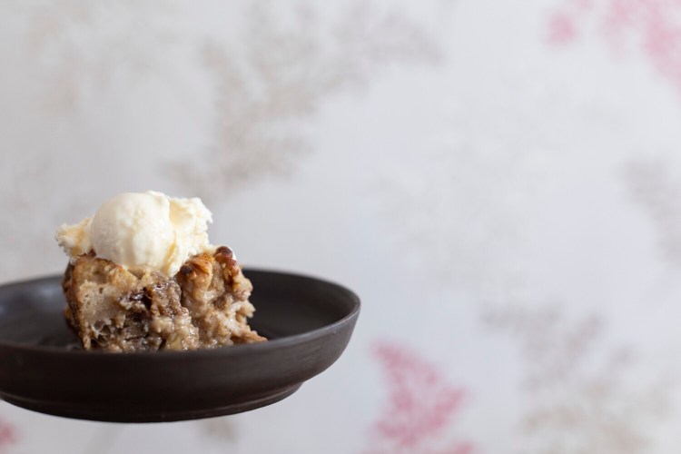 BRUNSWICK, ME - FEBRUARY 10: Christine Burns Rudalevige’s maple walnut bread pudding topped with ice cream and maple syrup on Thursday, February 10, 2022. (Staff photo by Brianna Soukup/Staff Photographer)