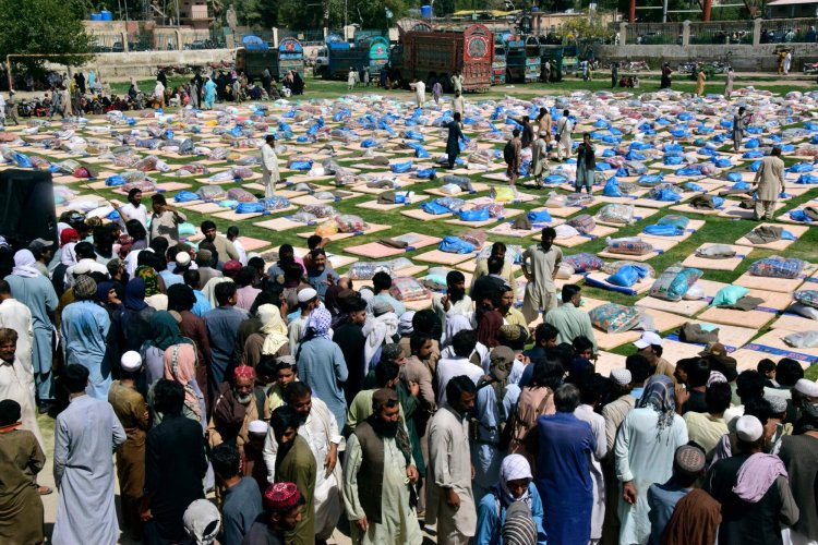 Victims of heavy flooding from monsoon rains wait to receive aid provided by the Allah-o-Akbar Tehreek political party on Sunday in Quetta, Pakistan. The unprecedented monsoon rains and subsequent floods around the country have destroyed more than a million homes.